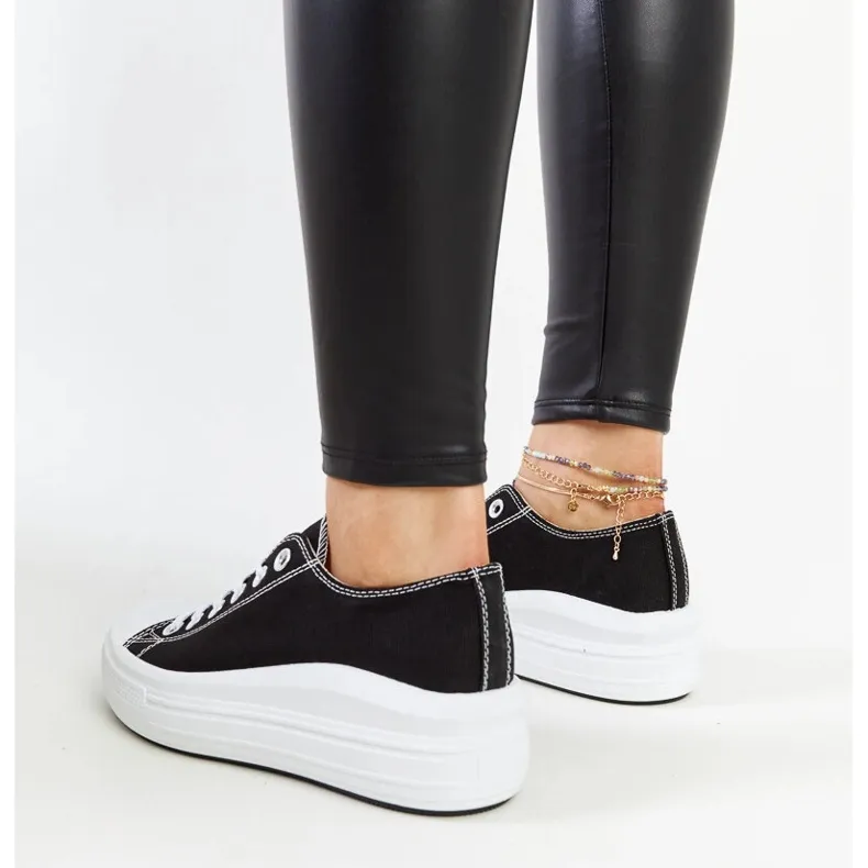 Black sneakers on a thick Zlata platform
